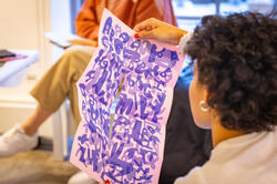 Student holding artwork