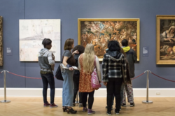 People observing a painting at the RISD Museum