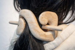 Long hair pinned up with wooden hair accessory