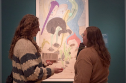 Two visitors in front of a museum item.