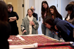 A group gathered around a study object in a museum