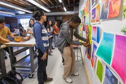 Students reviewing art work