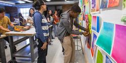 Students reviewing art work