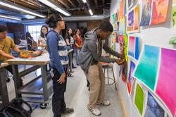 Students reviewing art work