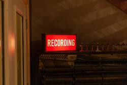 Image of a sign that reads "Recording." Image by Lucas Alexander, Unsplash